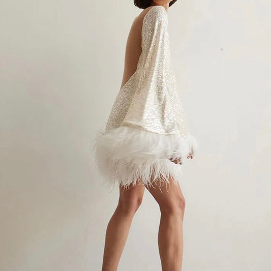 Glamorous dress with sequins and feather hem