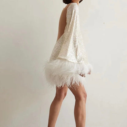 Glamorous dress with sequins and feather hem