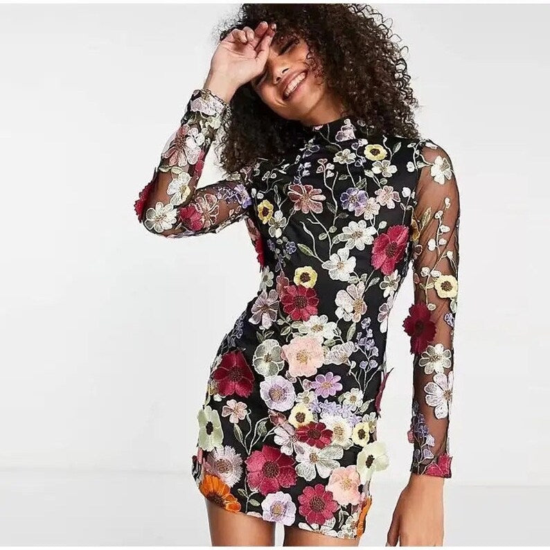 Mini dress with floral applications and translucent appearance