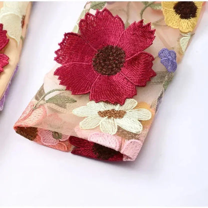 Mini dress with floral applications and translucent appearance