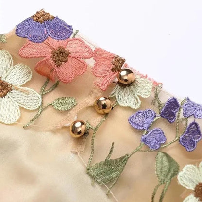 Mini dress with floral applications and translucent appearance